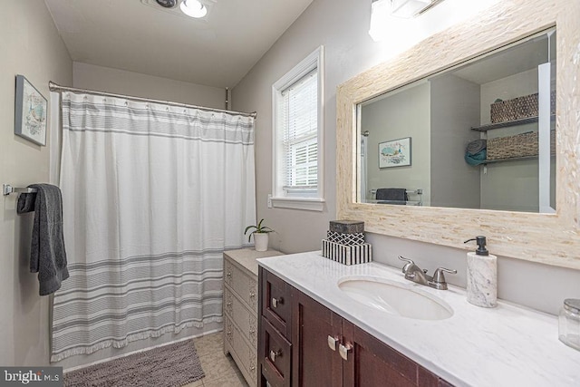 bathroom with vanity, a shower with shower curtain, and tile patterned flooring
