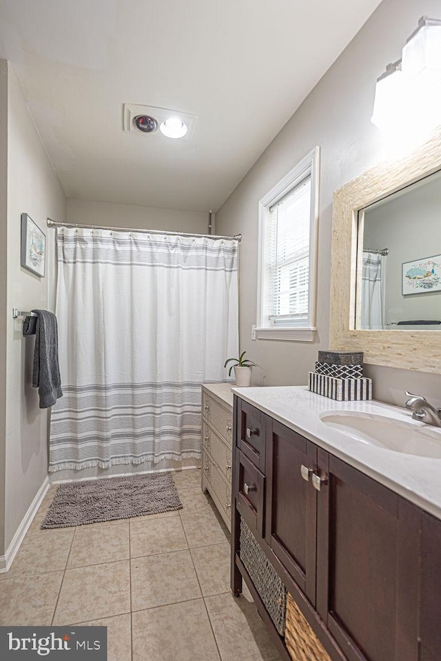 full bath featuring vanity, tile patterned floors, and curtained shower