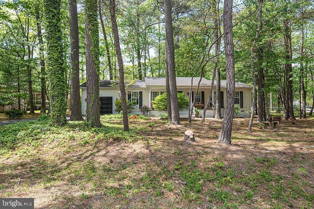 ranch-style home featuring a garage and covered porch
