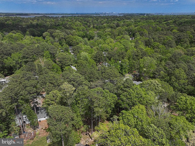 birds eye view of property with a view of trees