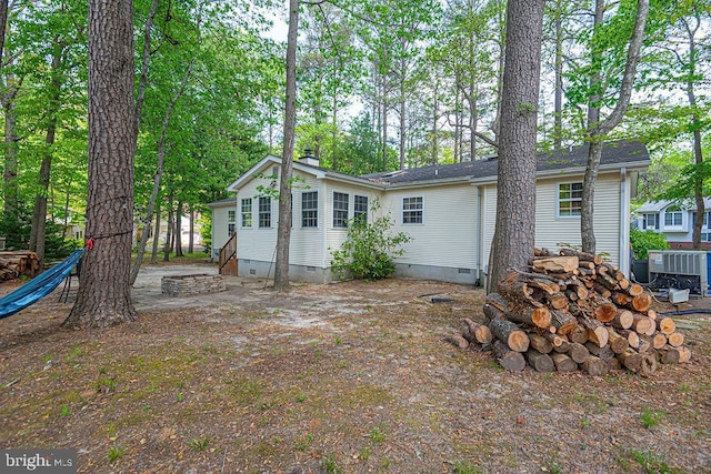 back of house with a chimney, central AC unit, and crawl space