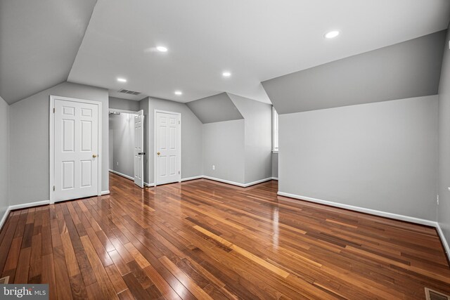 bonus room featuring vaulted ceiling, baseboards, wood-type flooring, and recessed lighting