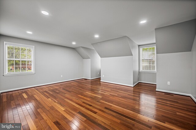 additional living space with hardwood / wood-style flooring, baseboards, lofted ceiling, and recessed lighting