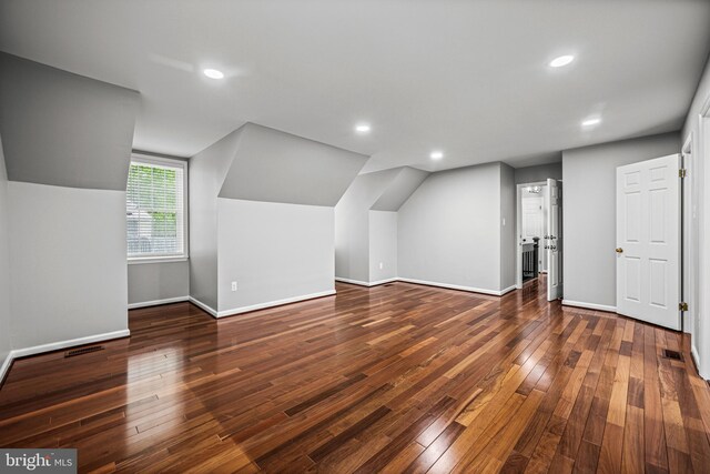 bonus room featuring baseboards, hardwood / wood-style floors, vaulted ceiling, and recessed lighting