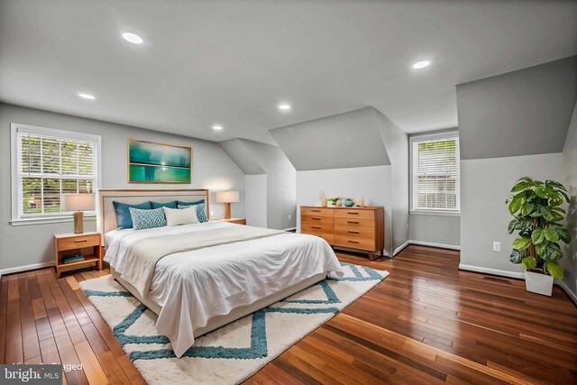 bedroom with baseboards, hardwood / wood-style floors, multiple windows, recessed lighting, and lofted ceiling