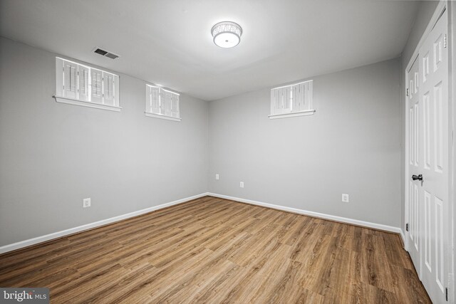 below grade area featuring baseboards and wood finished floors