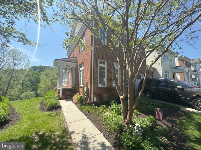 view of side of property featuring brick siding
