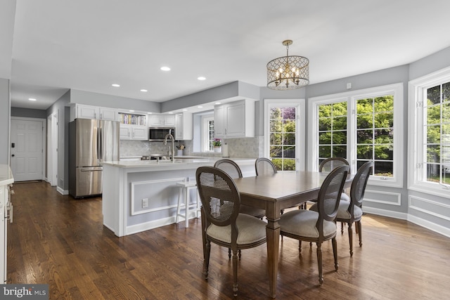 dining room with baseboards, recessed lighting, a chandelier, and dark wood-style floors