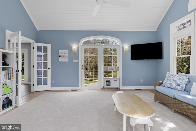 living area featuring carpet flooring, baseboards, french doors, and lofted ceiling