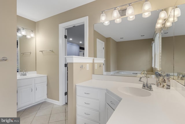 bathroom with a sink, tile patterned flooring, and two vanities