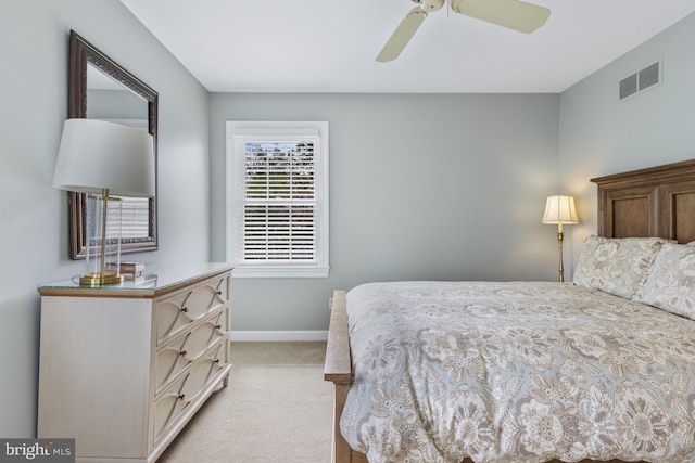 bedroom with baseboards, light colored carpet, and visible vents