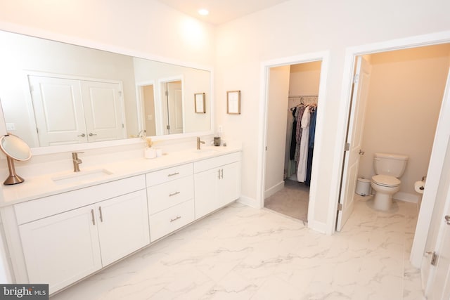 full bathroom with marble look tiles, double vanity, baseboards, toilet, and recessed lighting