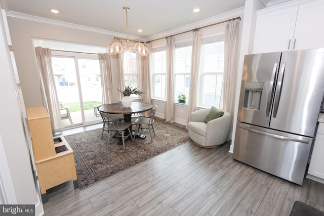 dining room featuring ornamental molding, a chandelier, light wood-type flooring, baseboards, and recessed lighting