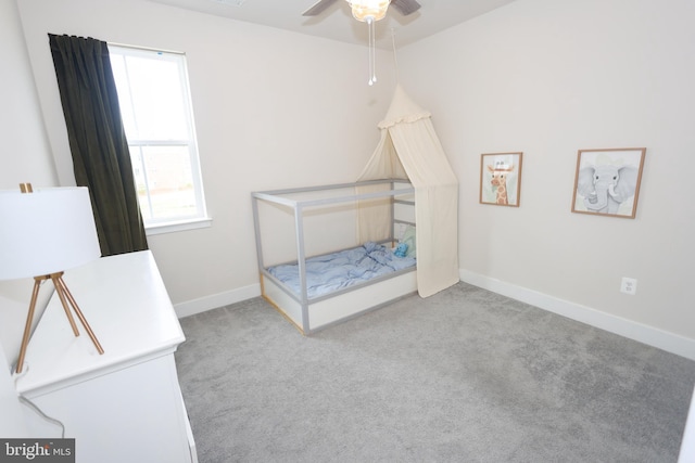 carpeted bedroom featuring baseboards