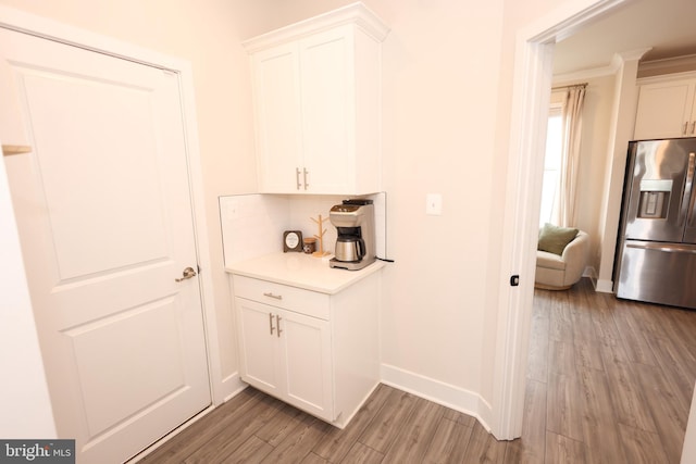 corridor featuring light wood-style floors and baseboards