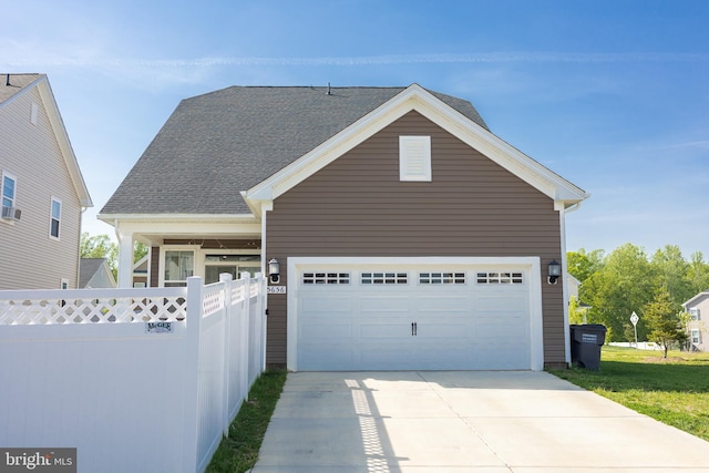 traditional-style home with fence and concrete driveway