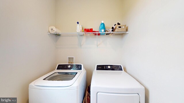 clothes washing area featuring washing machine and clothes dryer
