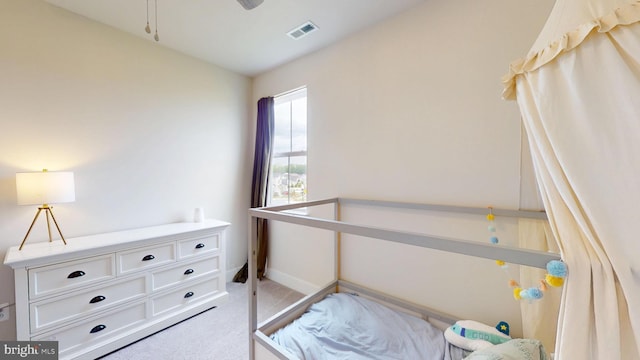 bedroom featuring light colored carpet and baseboards