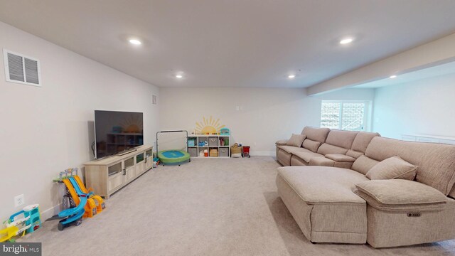 carpeted living area featuring recessed lighting and baseboards