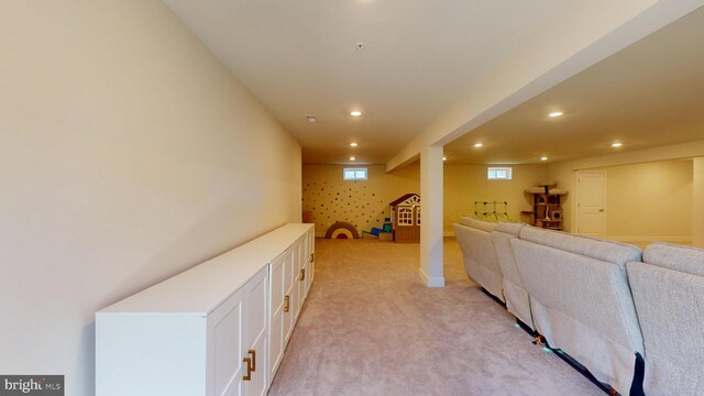 living area with recessed lighting and light colored carpet