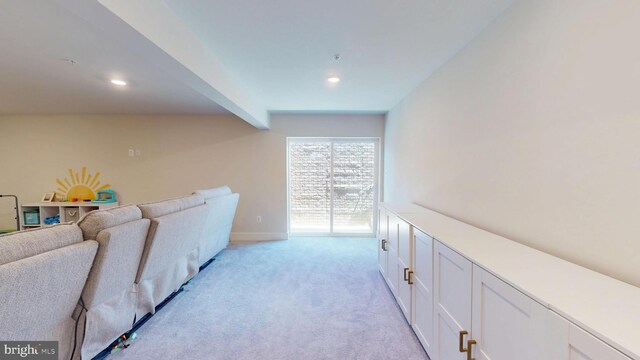 hallway with light colored carpet, recessed lighting, and baseboards