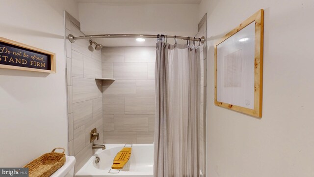 bathroom with toilet and shower / tub combo with curtain