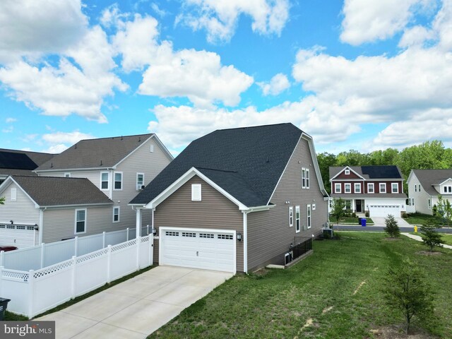 view of front of home with concrete driveway, a garage, a residential view, and roof with shingles
