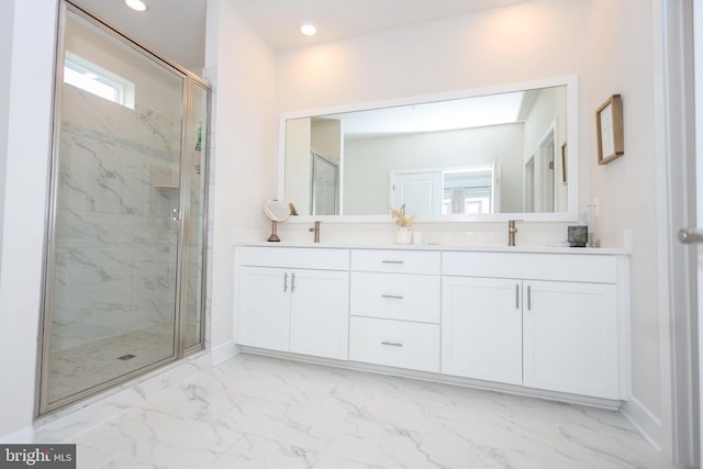 bathroom featuring a marble finish shower, marble look tile flooring, double vanity, and recessed lighting