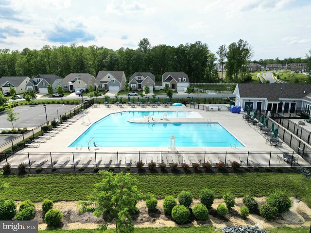 community pool with fence and a residential view