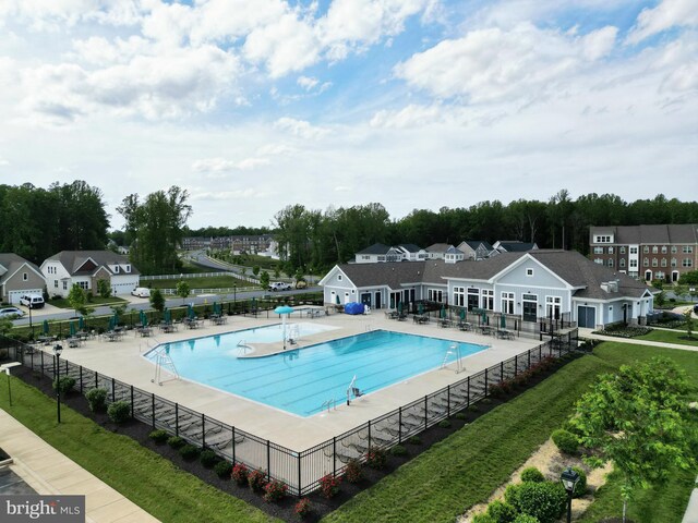 community pool featuring a patio area and a residential view