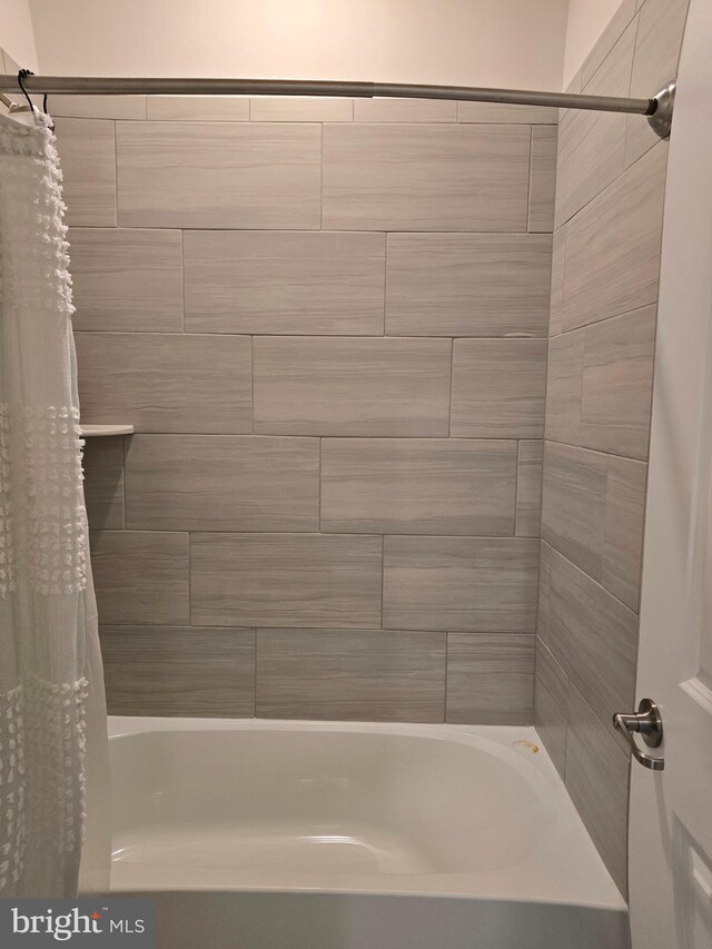 bathroom with shower / bath combination with curtain