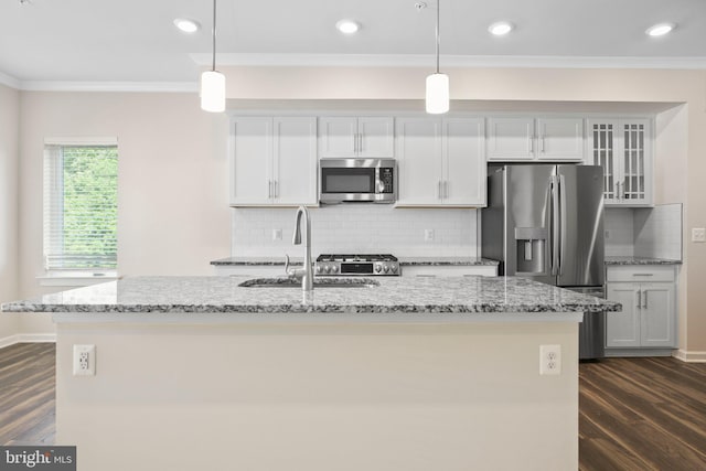 1398 Rail Stop Dr, Woodbridge, VA 22191 - kitchen featuring appliances with stainless steel finishes, ornamental molding, a sink, dark wood finished floors, and a center island with sink
