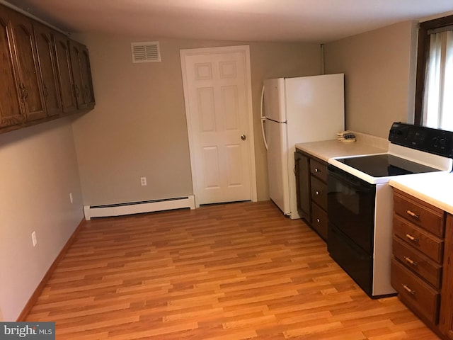 kitchen with electric range, light wood finished floors, visible vents, freestanding refrigerator, and a baseboard heating unit