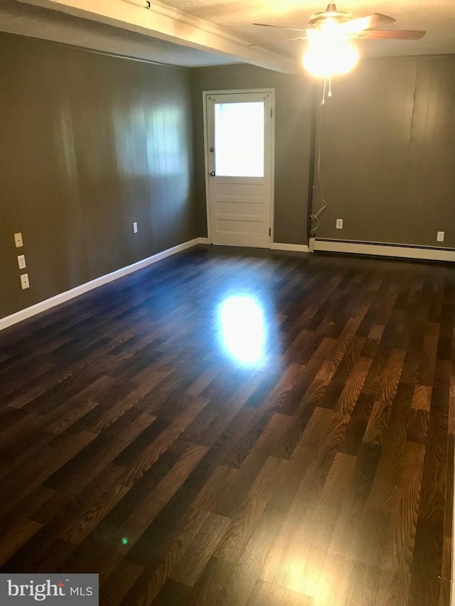 empty room featuring a ceiling fan, baseboards, dark wood-style floors, and a baseboard radiator