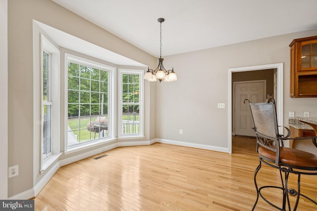 301 Gentle Breeze Cir, Fredericksburg, VA 22406 - unfurnished dining area featuring a chandelier and light wood-type flooring