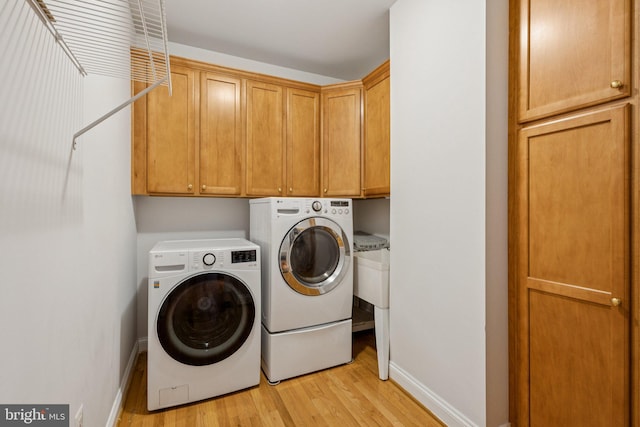 301 Gentle Breeze Cir, Fredericksburg, VA 22406 - laundry area with independent washer and dryer, light wood finished floors, and cabinet space