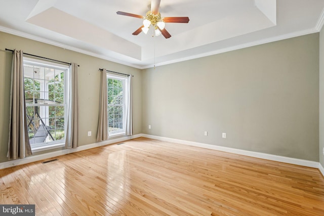 301 Gentle Breeze Cir, Fredericksburg, VA 22406 - empty room featuring a tray ceiling, light wood finished floors, a ceiling fan, and crown molding