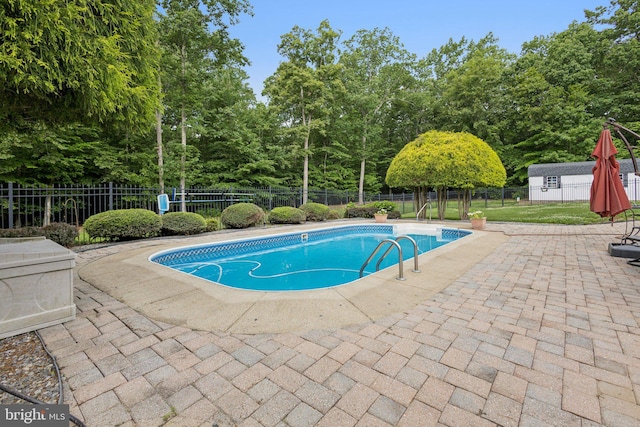 301 Gentle Breeze Cir, Fredericksburg, VA 22406 - view of swimming pool featuring a patio area, a fenced backyard, and view of wooded area