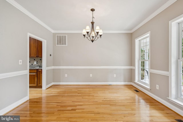 301 Gentle Breeze Cir, Fredericksburg, VA 22406 - unfurnished room with a chandelier, light wood-style flooring, and ornamental molding