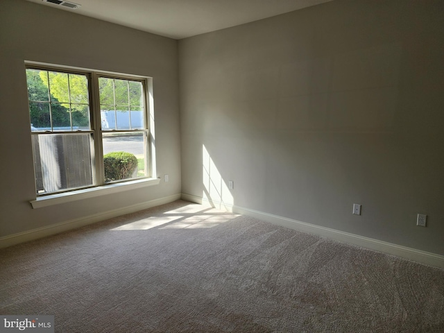 carpeted empty room with baseboards