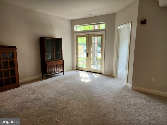 entryway with carpet flooring, baseboards, and french doors