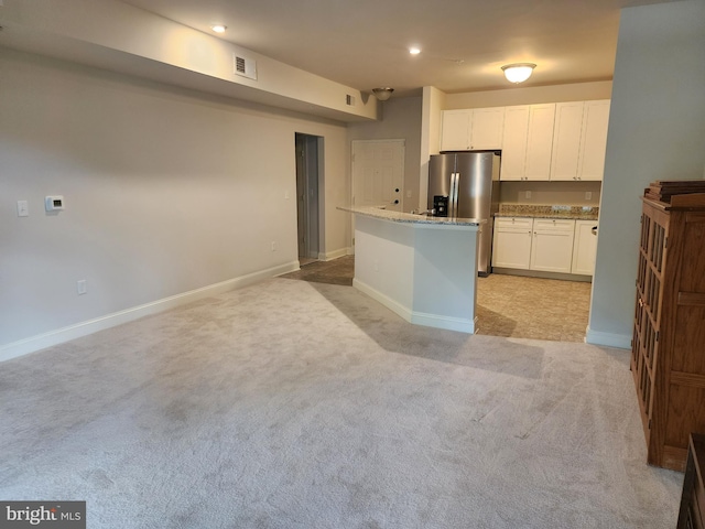 kitchen with light carpet, white cabinets, baseboards, stainless steel refrigerator with ice dispenser, and light stone countertops