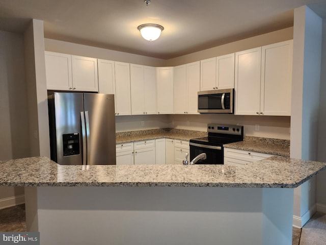 kitchen with stainless steel appliances, baseboards, light stone countertops, and white cabinetry