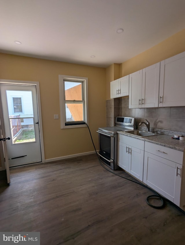 kitchen with a sink, dark wood-style floors, white cabinets, and stainless steel electric range oven