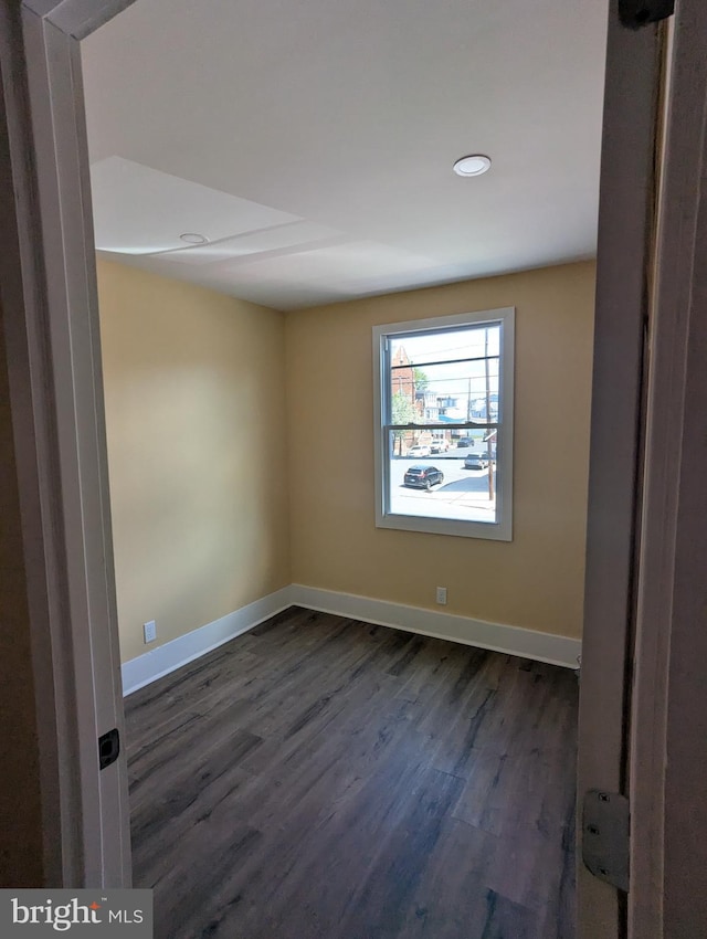 unfurnished room featuring baseboards, recessed lighting, and dark wood-type flooring