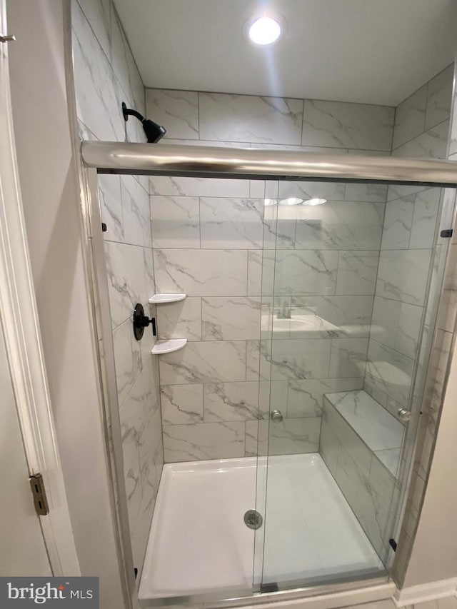 bathroom with recessed lighting and a stall shower