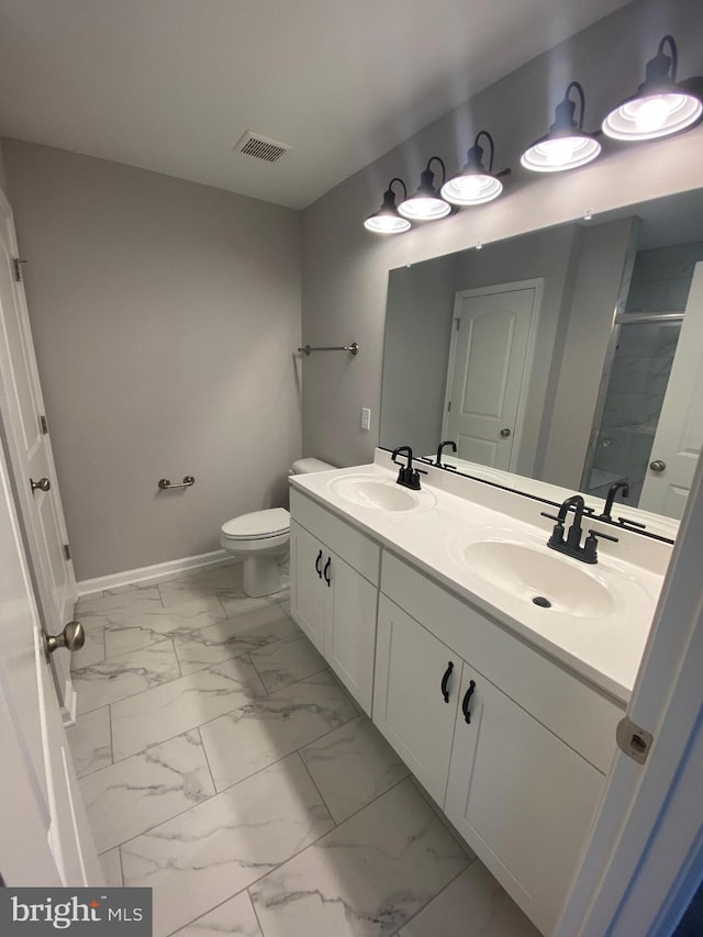bathroom featuring a sink, baseboards, a shower, and marble finish floor