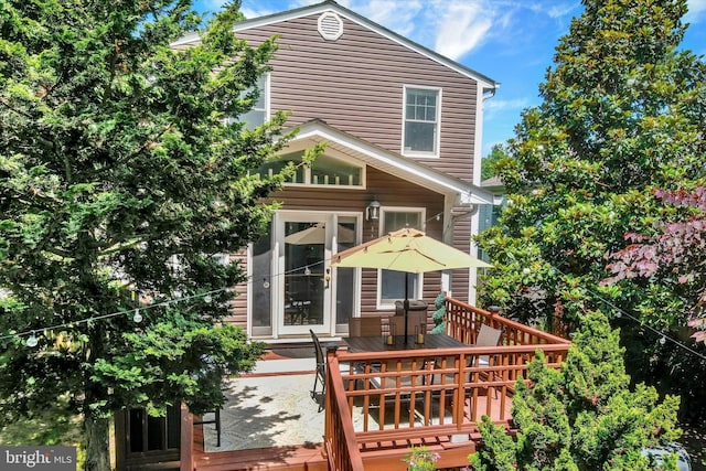 7707 W Dr, Glen Burnie, MD 21060 - rear view of property featuring a wooden deck and outdoor dining space