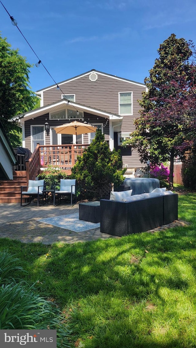 7707 W Dr, Glen Burnie, MD 21060 - back of property with a patio, an outdoor living space, a lawn, and a deck