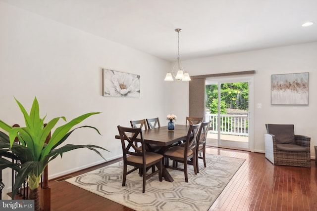 dining area with recessed lighting, baseboards, an inviting chandelier, and hardwood / wood-style flooring